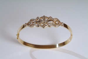 Art Deco inspired gold and diamond bangle.